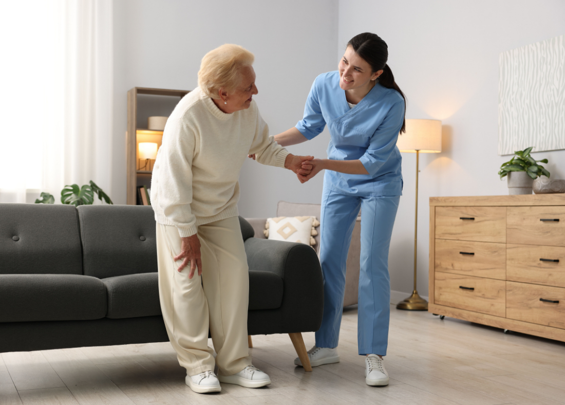 A carer helping a client move safely around her living room